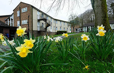 Exterior of Hothersall Lodge with daffodils