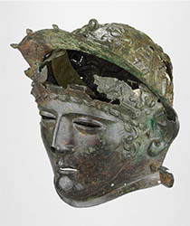 Copper alloy cavalry helmet with face-mask visor. Decorated with a scene of a skirmish between infantry and cavalry.  © The Trustees of the British Museum