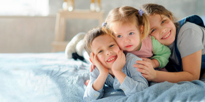 3 foster siblings hugging