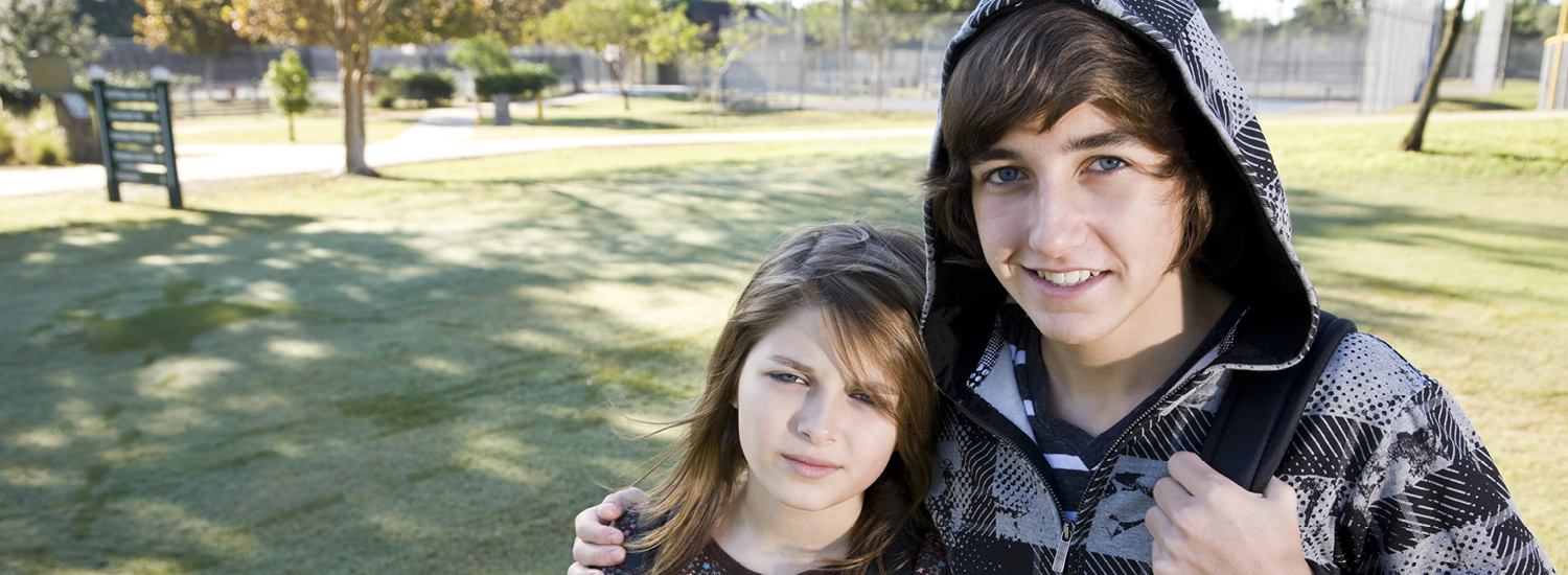 Teenage foster children hugging